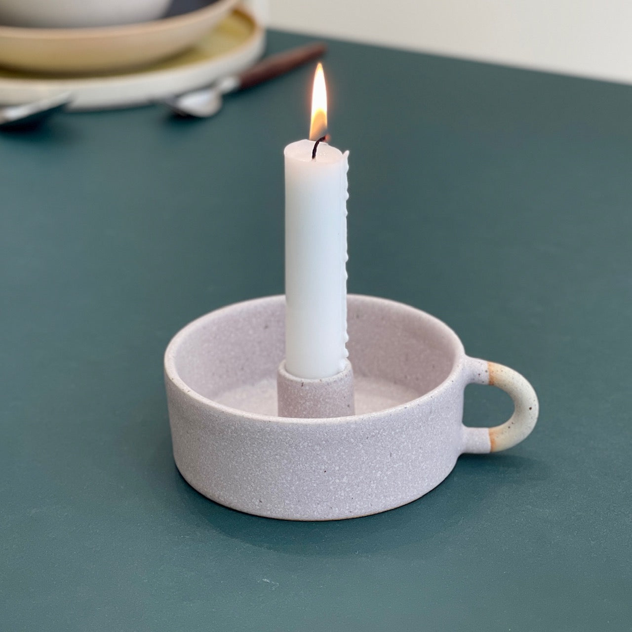 Candleholder with a handle